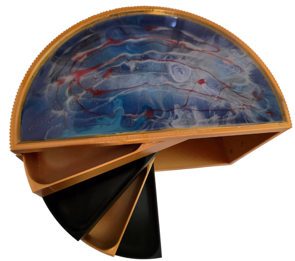 A semi-circular decorative tray or box with a marbled blue, white, and red resin top, a gold-toned rim, and open lower compartments showing black and tan interior panels on a light gray background.